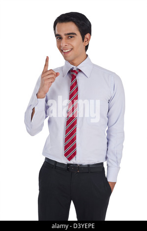 Portrait of a businessman pointing and smiling Stock Photo