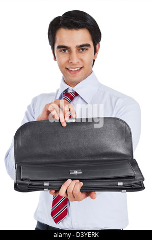 Businessman holding a bag and smiling Stock Photo