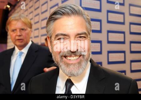 Baden-Baden, Germany. 26th February 2013. The prizer winner of the German Media Prize 2012, US actor George Clooney (R), arrives for the award ceremony with Karlheinz Koegel of Media Control  in Baden-Baden, Germany, 26 February 2013. Photo: Uli Deck/dpa/Alamy Live News Stock Photo