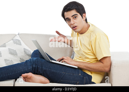 Surprised man using a laptop Stock Photo