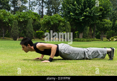 Man doing push-ups in a park Stock Photo