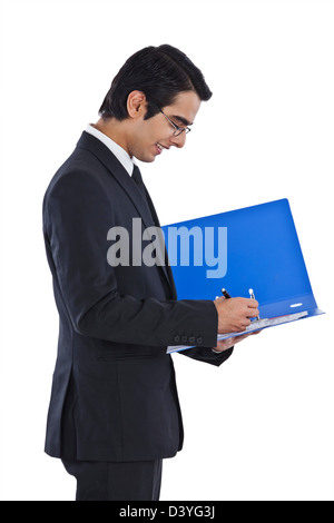 Businessman examining documents and smiling Stock Photo