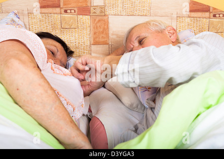 Close up of senior couple seducing in bed. Stock Photo