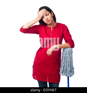 Woman leaning on a mop and suffering from a headache Stock Photo