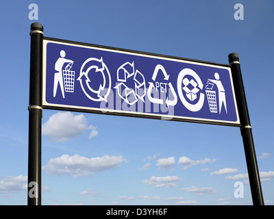 Dark blue information sign with various recycling symbols over blue sky Stock Photo