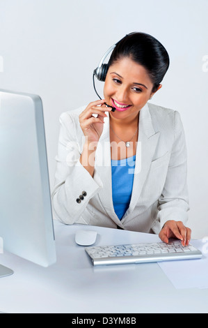 Female customer service representative using a desktop pc Stock Photo