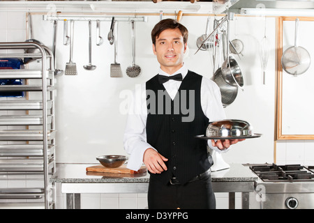 Young Waiter With Cloche Lid Cover And Tray Stock Photo