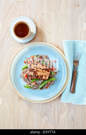 Salmon on Soba Noodles with Peas and Tomato Stock Photo