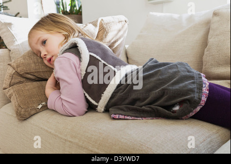 Girl Lying on Sofa Stock Photo
