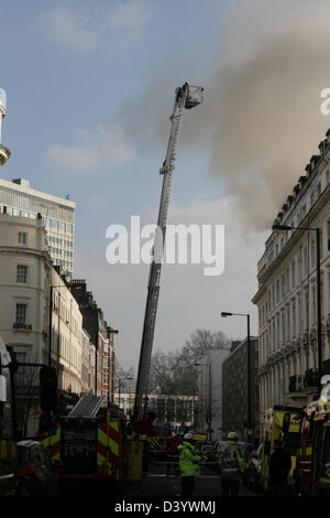 London, UK, 27 February 2013, Firefighters aim hoses at blaze in Bayswater hotel. Station Manager Nick Comery, who was at the scene, said: 'Firefighters worked hard and did well tackle a challenging and well developed fire. Fifteen people escaped from the building before the crews arrived and thankfully no one was hurt. Our fire investigation team is now working to determine what caused the blaze.'  Credit:  martyn wheatley / Alamy Live News Stock Photo