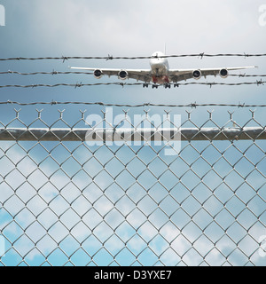 Jumbo Jet and Chain Link Fence with Barbed Wire, Pearson International Airport, Toronto, Ontario, Canada Stock Photo