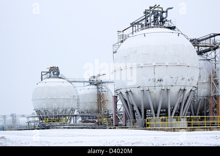 round oil tanks under snow cover Stock Photo