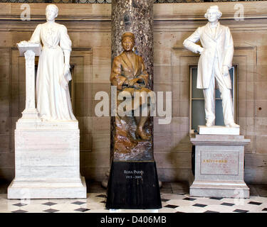 A statue of civil rights activist Rosa Parks stands in National Statuary Hall in the United States Capitol after being unveiled February 27, 2013 in Washington, DC. Rosa Parks, whose arrest in 1955 for refusing to yield her seat on a segregated bus to a white passenger helped ignite the modern American civil rights movement. This bronze statue depicts Parks seated on a rock-like formation of which she seems almost a part, symbolizing her famous refusal to give up her bus seat. The statue is close to nine feet tall including its pedestal.