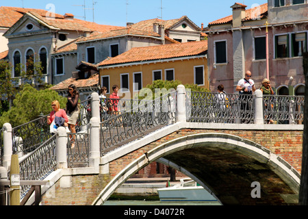 One of the bridges in Venice, Italy. Traditional venetian houses with red tiles on the background Stock Photo