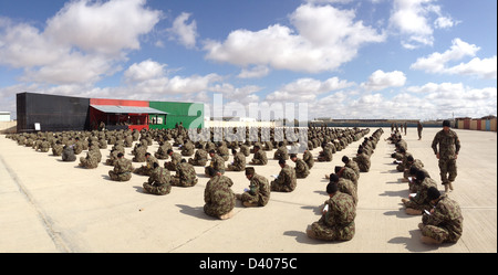 An Afghan National Army battalion commander at the Regional Military Training Center at Camp Shorabak monitors soldiers taking placement exams February 21, 2013 in Helmand province, Afghanistan. Stock Photo