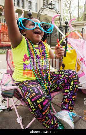 Young girl shouting for beads on Mardi Gras day, New Orleans. Stock Photo