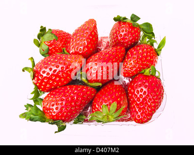 Fresh Strawberry piled in clear plastic box Isolated on white background Stock Photo