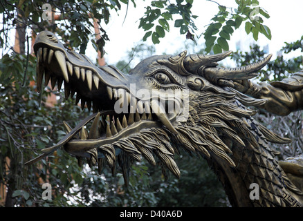 It's a photo of the head of a dragon or animal. We can see it's a statue of a dragon in a entertainment park Stock Photo