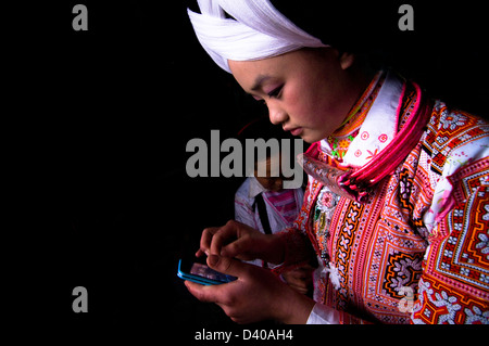 Long Horn Miao teenage girls getting ready for the Tiao Hua festival in Guizhou. Stock Photo