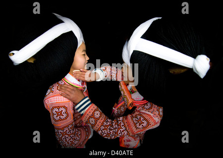 Long Horn Miao teenage girls getting ready for the Tiao Hua festival in Guizhou. Stock Photo