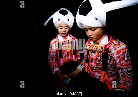 Long Horn Miao teenage girls getting ready for the Tiao Hua festival in Guizhou. Stock Photo