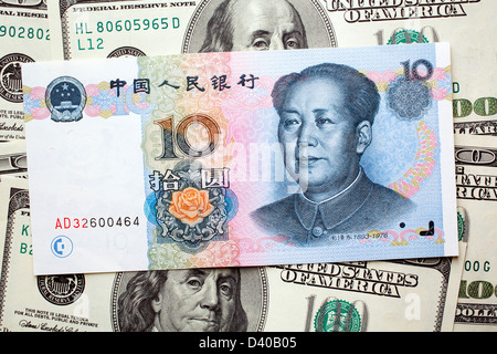 10 Yuan banknote with Mao Zedong and 100 Dollars banknotes as background Stock Photo