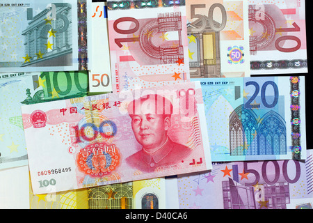 100 Yuan banknote with Mao Tse-tung, China (2005) and Euro banknotes of different denominations as background Stock Photo