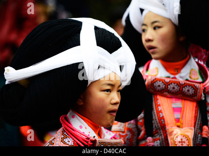 A Long Horn Miao little girl in traditional costumes dancing to celebrate the Tiao Hua festival / spring festival in Guizhou. Stock Photo