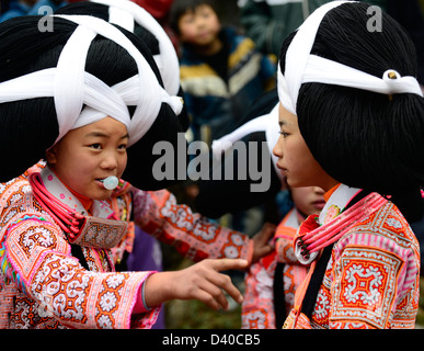 A Long Horn Miao little girl in traditional costumes dancing to celebrate the Tiao Hua festival / spring festival in Guizhou. Stock Photo