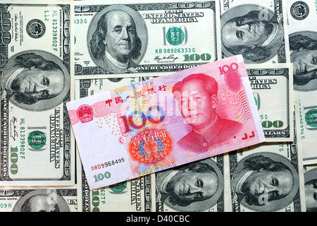 Chinese 100 Yuan banknote with Mao Zedong and 100 US Dollars banknotes as background Stock Photo