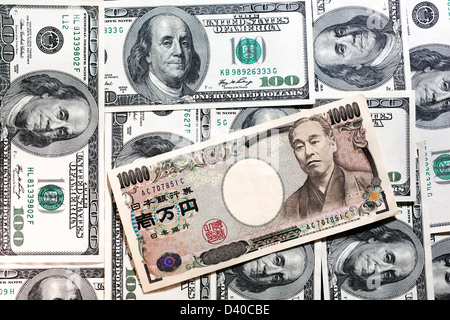 Japanese 10000 Yen banknote with Yukichi Fukuzawa and 100 US Dollars banknotes as background Stock Photo