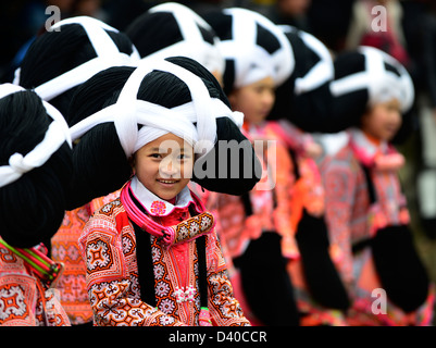 A Long Horn Miao little girl in traditional costumes dancing to celebrate the Tiao Hua festival / spring festival in Guizhou. Stock Photo