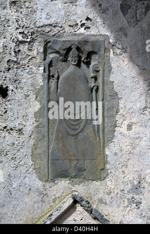 Stone Carving of A Bishop on a wall inside Corcomroe Abbey, 13th Century Cistercian Monastery, The Burren, Co Clare, Ireland Stock Photo