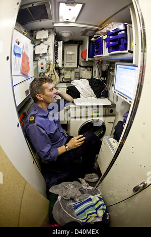 Crew man in laundry room of Nuclear Submarine HMS Talent Stock Photo