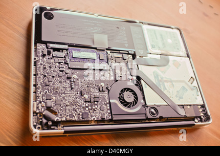 Apple Macbook Pro with base removed, showing internal components including circuitry. Stock Photo