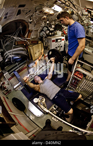 Working out with weights on Nuclear Submarine HMS Talent Stock Photo