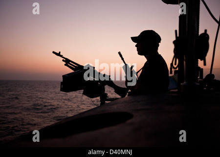 Guard on deck of Nuclear Submarine HMS Talent with machine gun Stock Photo