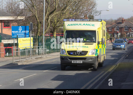 Royal Bolton Hospital,Lancashire. 28th February 2013. Ambulance  with blue flashing lights on Minerva Road approaching the Royal Bolton Hospital. Stock Photo