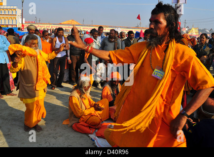 A group of Sadhus, Hindu holymen, dance near holy Ganges river during the auspicious bathing day of the Maha Kumbh Mela in Allah Stock Photo