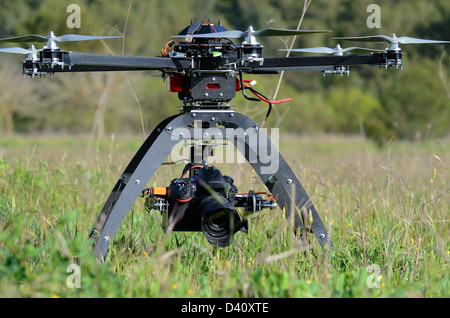 Drone and digital camera on an Unmanned Aerial Vehicle (UAV or Drone), with six rotors, used here for aerial photography or filming Stock Photo