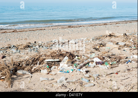 Plastic bottles and other rubbish and waste washed up on a dirty British beach