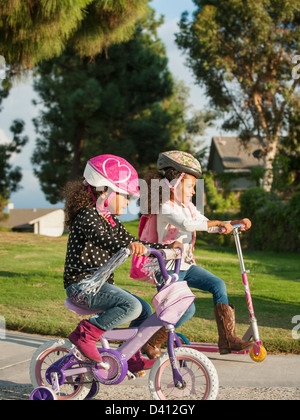 Mixed race girls playing outdoors Stock Photo