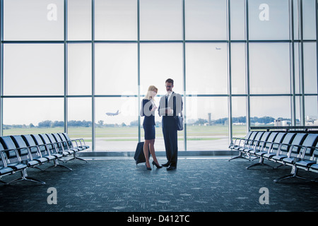 Caucasian business people standing in airport Stock Photo