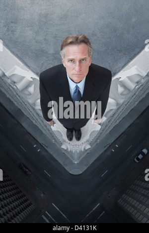Caucasian businessman on skyscraper ledge Stock Photo