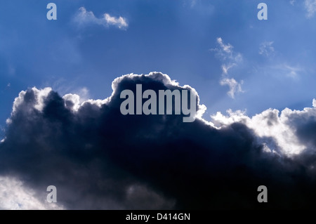 Dark storm cloud building in blue sky Stock Photo