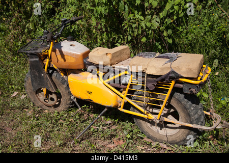 Old, used and small motorcycle with knobby tires.