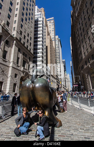 Tourists at The bull of Wall Street, Financial district, New York City, USA  Stock Photo