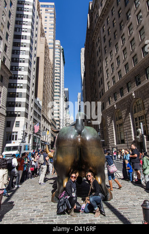 Tourists at The bull of Wall Street, Financial district, New York City, USA  Stock Photo