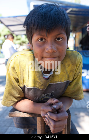 A young shoe shine boy in the market in Granada Nicaragua Stock Photo