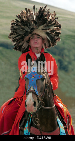 Native American Indian boy on horse with feather head dress Prairie's South Dakota, USA Stock Photo